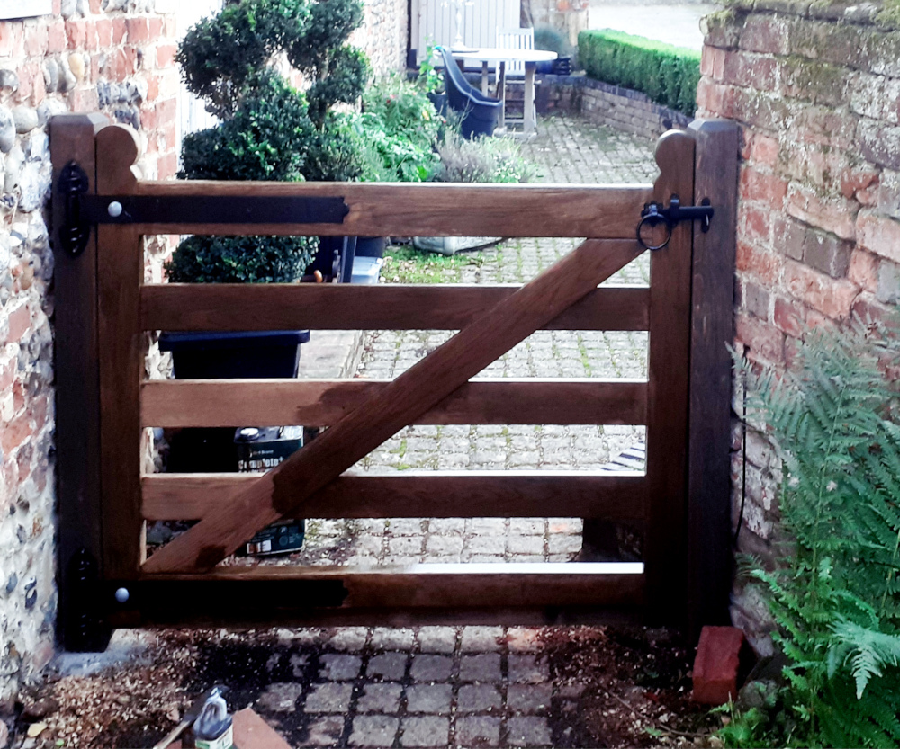 Small garden gate finished with wood stain